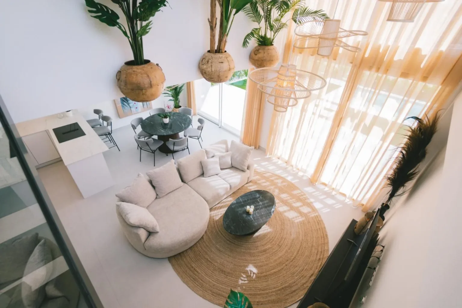 Bright living room with round sofa and jute rug in the Bella furniture store